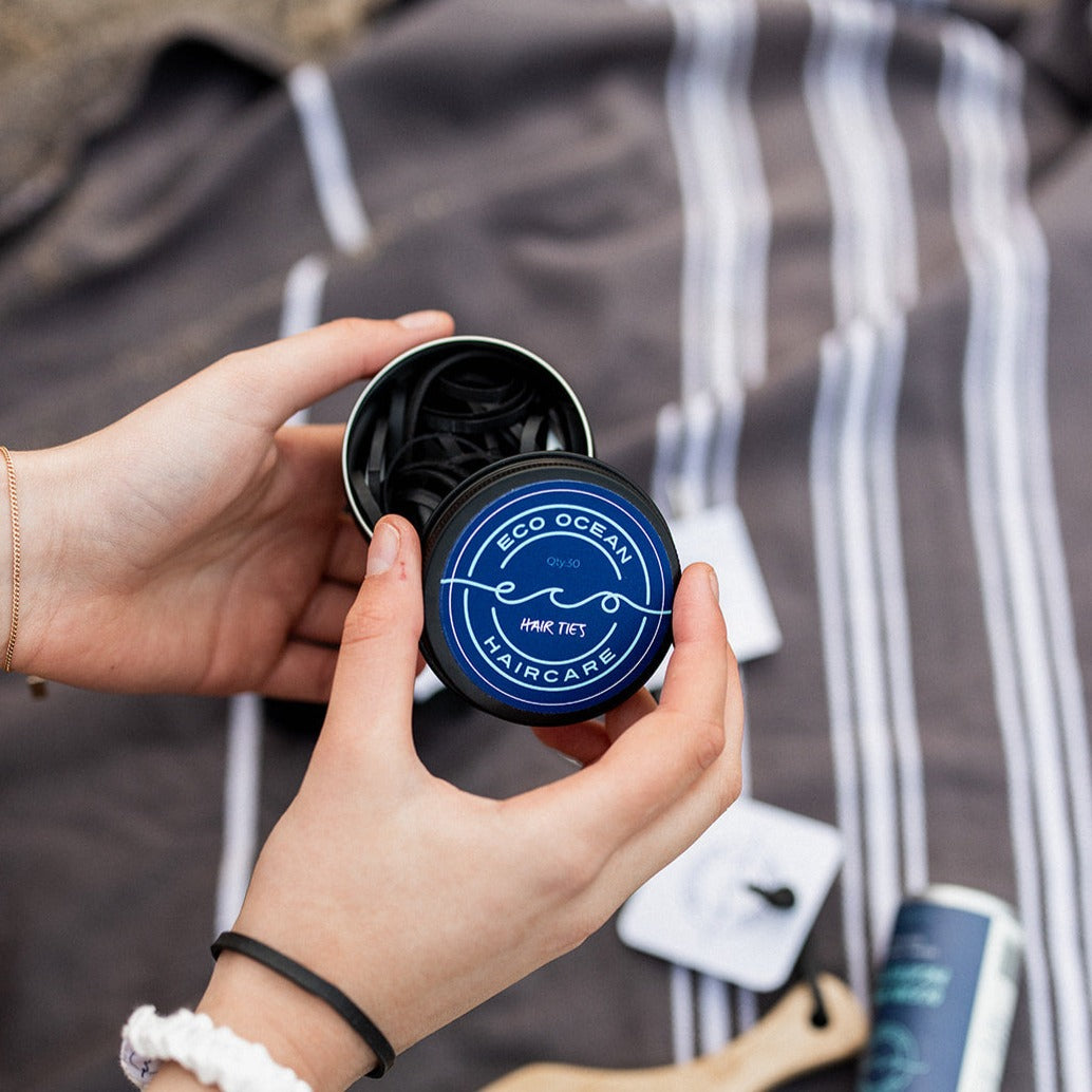 Woman with open tub of rubber eco hair ties.