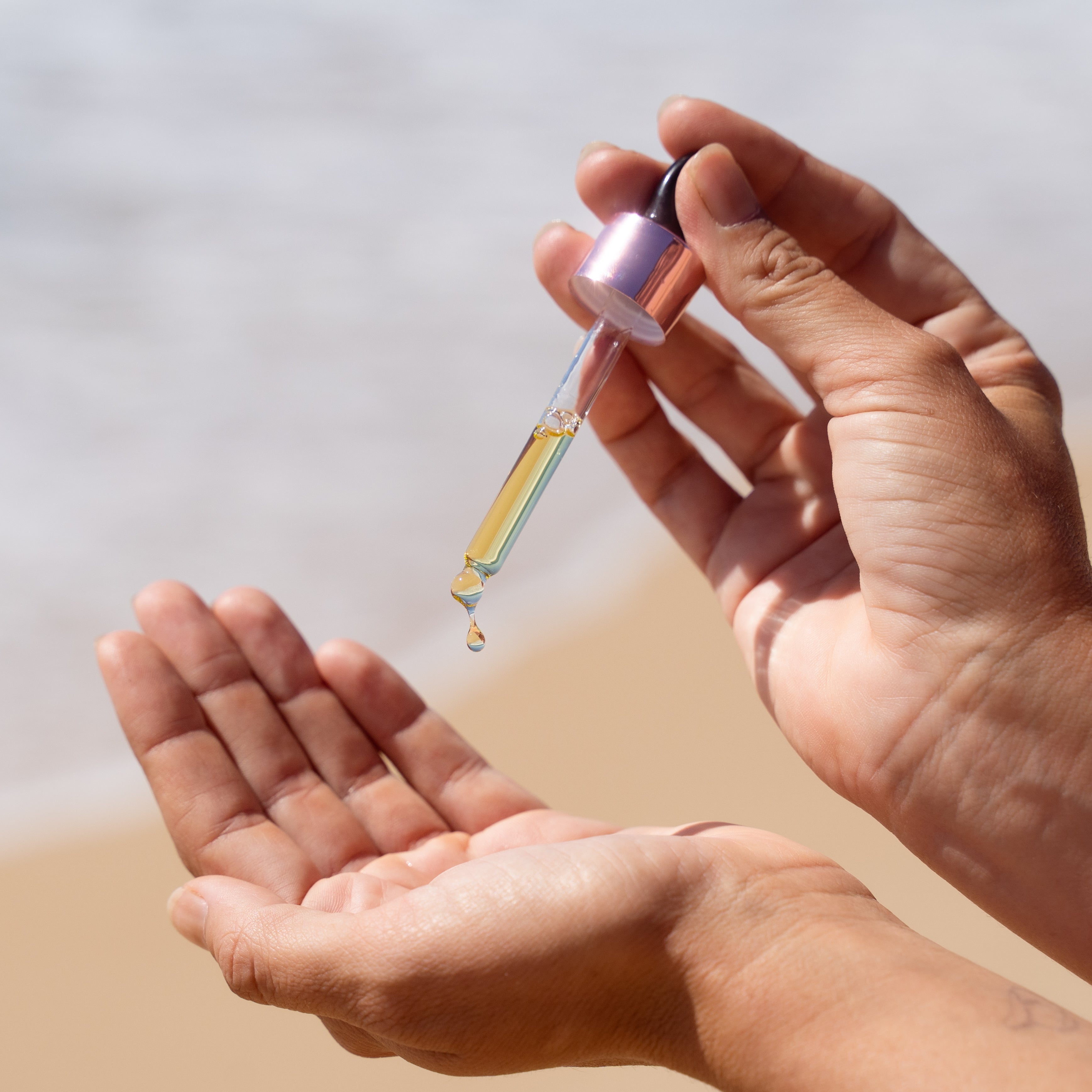 Woman using dropper for Silky Serum hair drops