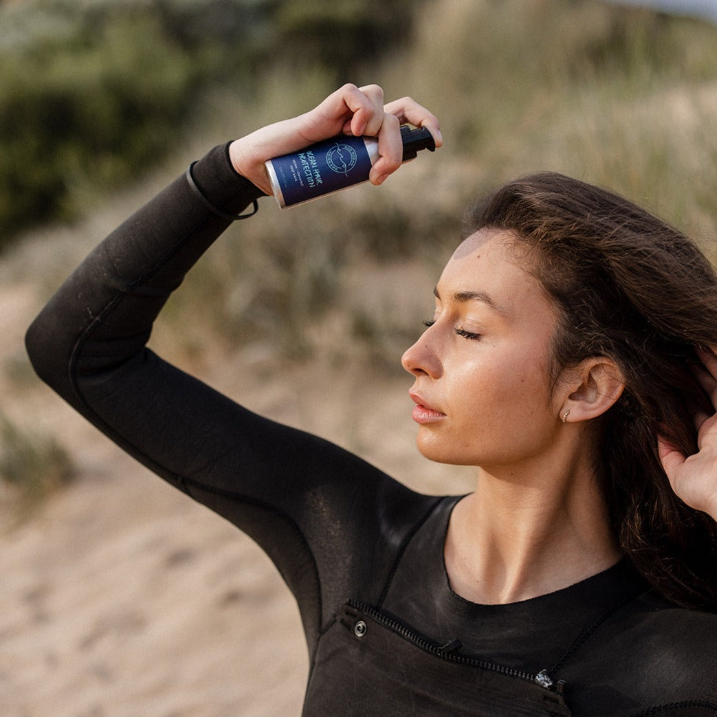 Woman using Ocean Hair Protection after a swim