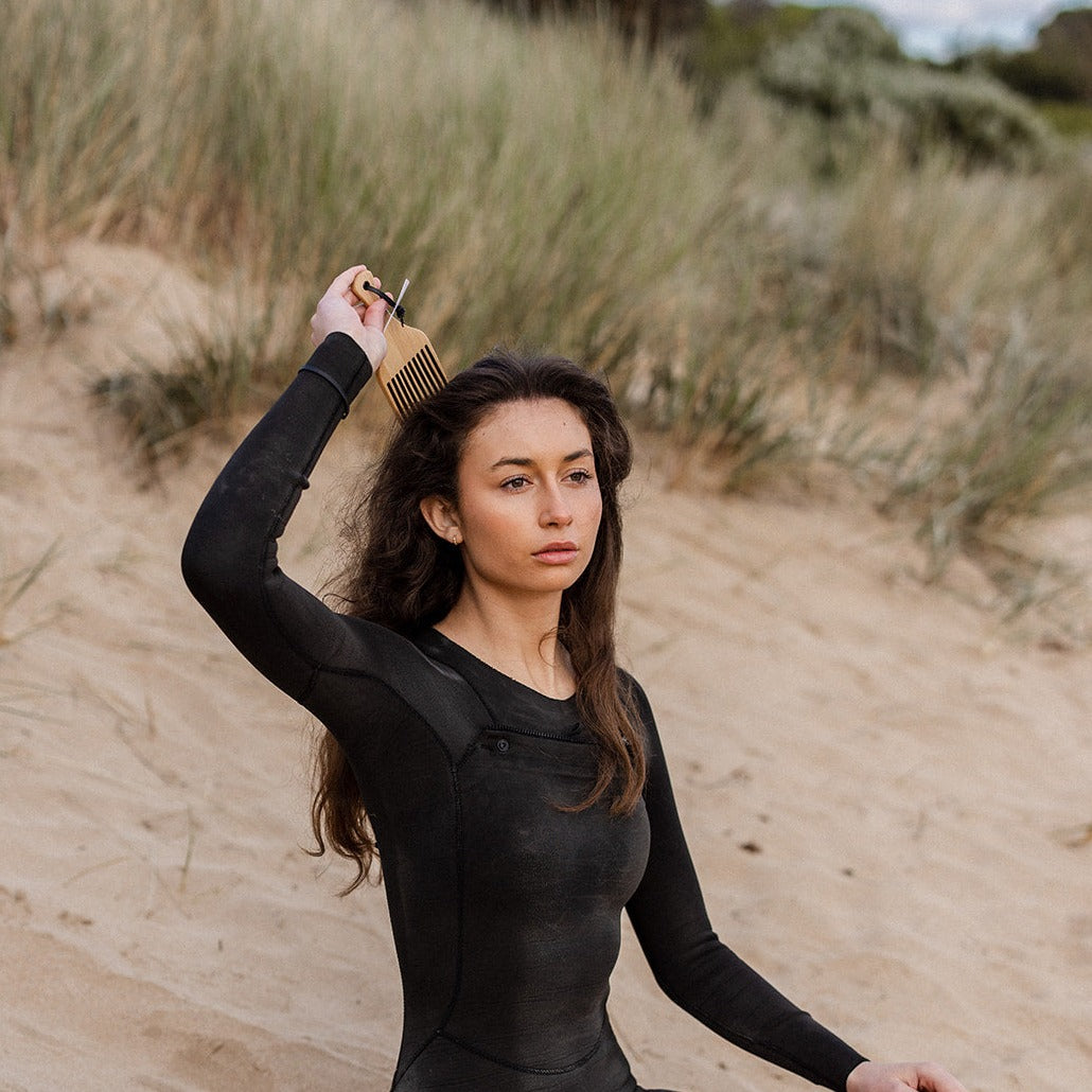 Woman using Eco Ocean Haircare Bamboo Comb to comb her long hair