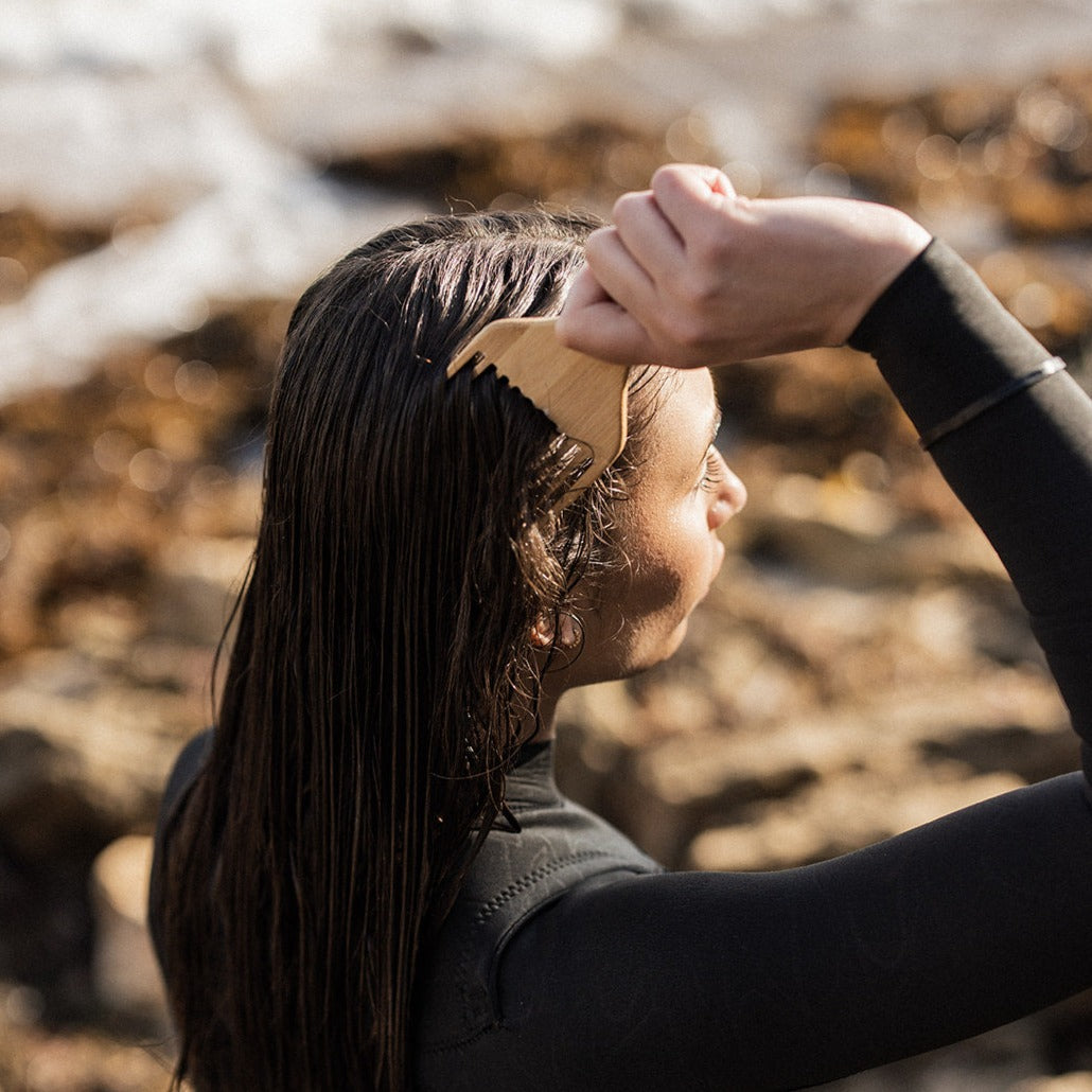 Woman using eco Ocean Haircare Bamboo Comb