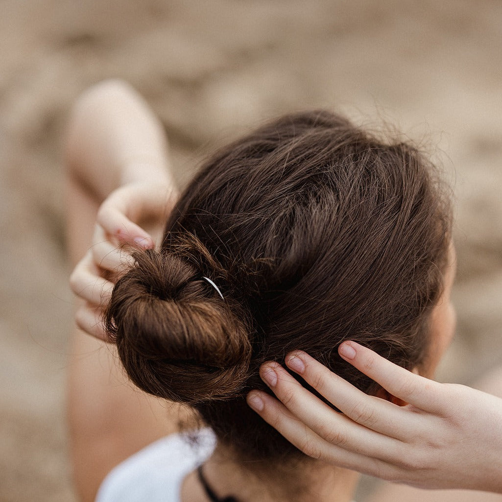 Woman using plastic-free eco ocean hair fork